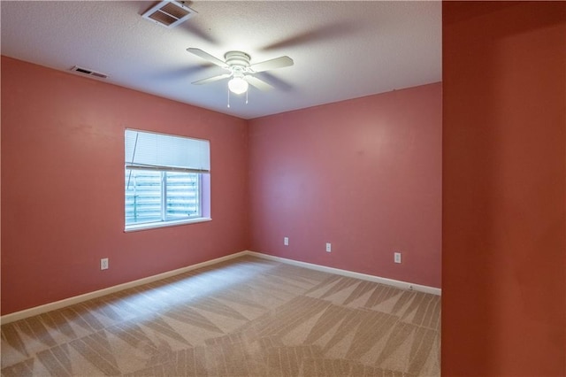 404 Wyndham Dr, Lansing, KS 66043 - spare room with light colored carpet, a ceiling fan, and a textured ceiling