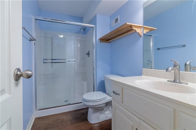 404 Wyndham Dr, Lansing, KS 66043 - full bath featuring vanity, a shower stall, and wood finished floors