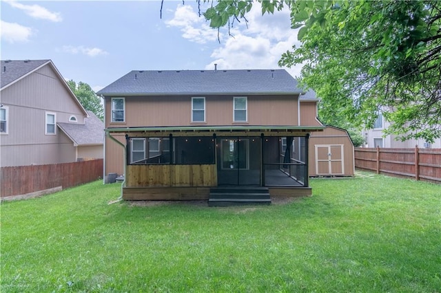 404 Wyndham Dr, Lansing, KS 66043 - back of property with a sunroom, a fenced backyard, a shed, entry steps, and roof with shingles