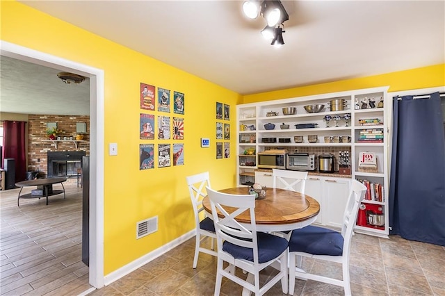 3722 Robinson Pike Rd, Grandview, MO 64030 - dining space with a fireplace and baseboards