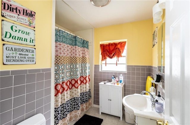 3722 Robinson Pike Rd, Grandview, MO 64030 - bathroom with tile walls, tile patterned floors, a wainscoted wall, and curtained shower
