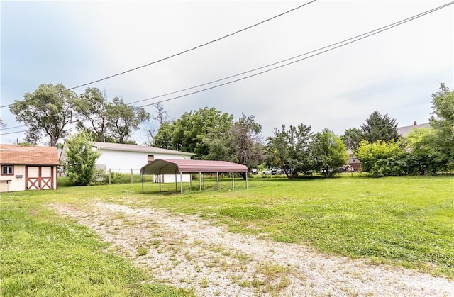 3722 Robinson Pike Rd, Grandview, MO 64030 - view of grassy yard featuring a carport, dirt driveway, and a storage unit