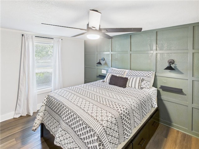 307 E 4th St, Holden, MO 64040 - bedroom with a decorative wall, wood finished floors, and a ceiling fan