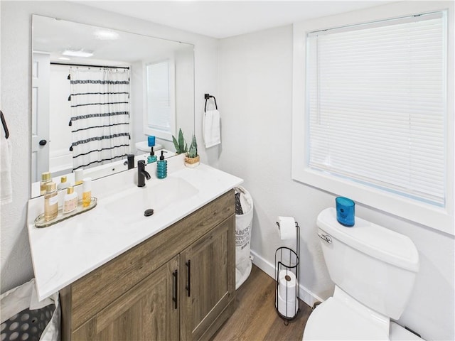 307 E 4th St, Holden, MO 64040 - bathroom featuring vanity, wood finished floors, and curtained shower