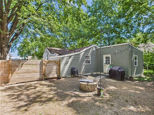 307 E 4th St, Holden, MO 64040 - back of property featuring a gate and a fire pit