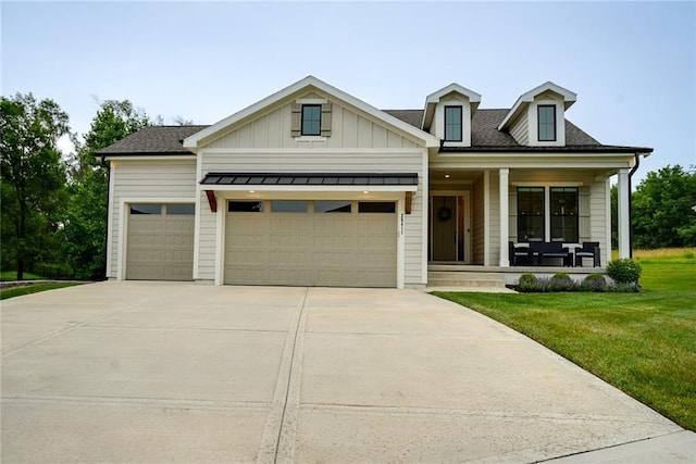 25411 W 142nd Pl, Olathe, KS 66061 - view of front facade with a porch, an attached garage, concrete driveway, a front lawn, and board and batten siding