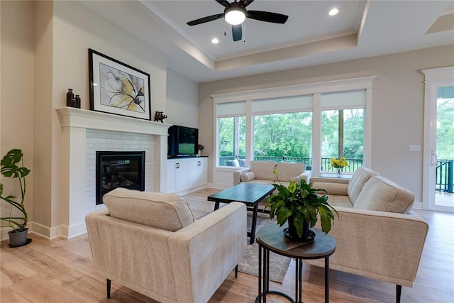 25411 W 142nd Pl, Olathe, KS 66061 - living room featuring a raised ceiling, healthy amount of natural light, light wood-type flooring, and recessed lighting