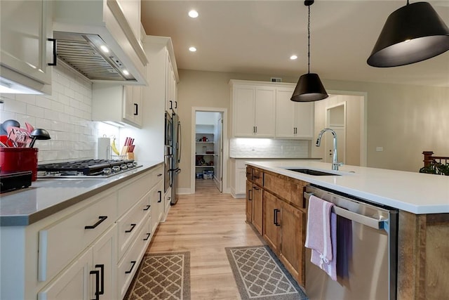25411 W 142nd Pl, Olathe, KS 66061 - kitchen with stainless steel appliances, custom exhaust hood, decorative backsplash, light wood-style flooring, and recessed lighting