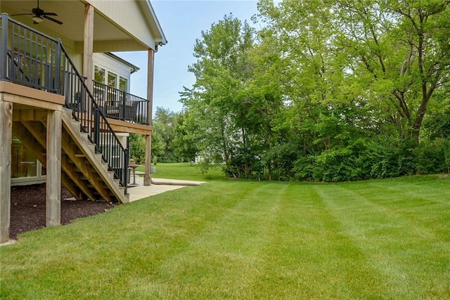 25411 W 142nd Pl, Olathe, KS 66061 - view of green lawn with a ceiling fan and stairs