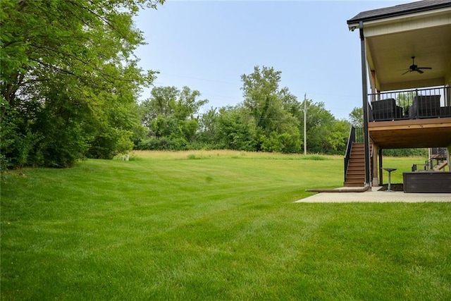 25411 W 142nd Pl, Olathe, KS 66061 - view of grassy yard featuring stairs, ceiling fan, a wooden deck, and a patio