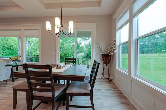25411 W 142nd Pl, Olathe, KS 66061 - dining room with light wood finished floors, a tray ceiling, and a chandelier