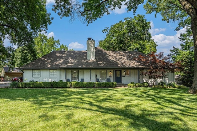 3818 W 52nd Ter, Roeland Park, KS 66205 - view of front of property with a front yard, a chimney, covered porch, and board and batten siding