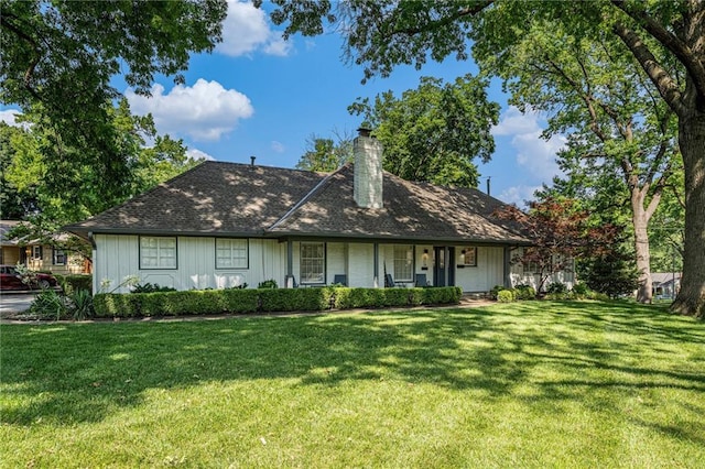 3818 W 52nd Ter, Roeland Park, KS 66205 - view of front facade with a front yard, a chimney, covered porch, and board and batten siding