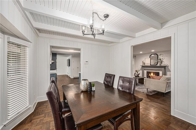 3818 W 52nd Ter, Roeland Park, KS 66205 - dining room with a chandelier, beamed ceiling, and a warm lit fireplace