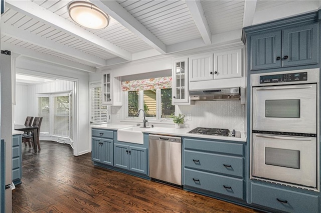 3818 W 52nd Ter, Roeland Park, KS 66205 - kitchen featuring appliances with stainless steel finishes, blue cabinets, beam ceiling, light countertops, and healthy amount of natural light