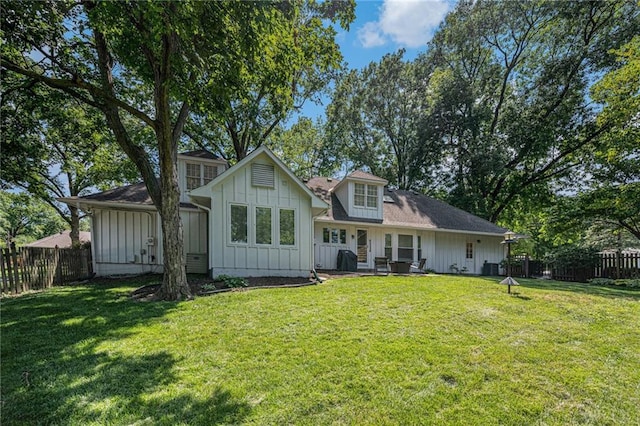 3818 W 52nd Ter, Roeland Park, KS 66205 - rear view of property featuring board and batten siding and a fenced backyard