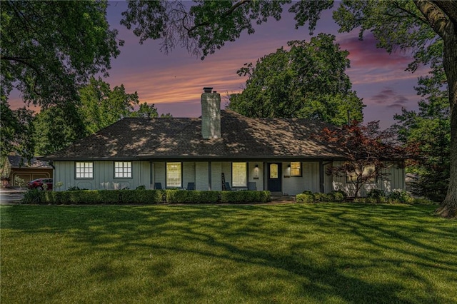 3818 W 52nd Ter, Roeland Park, KS 66205 - view of front facade with a chimney, a front lawn, board and batten siding, and covered porch