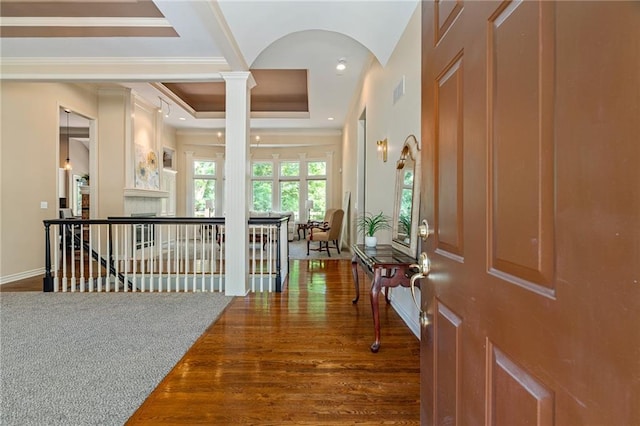 14740 W 128th St, Olathe, KS 66062 - foyer entrance featuring ornate columns, ornamental molding, wood finished floors, arched walkways, and a fireplace