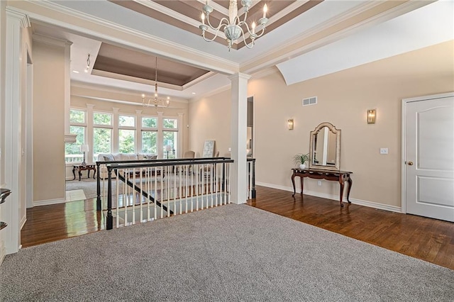 14740 W 128th St, Olathe, KS 66062 - corridor with a chandelier, crown molding, an upstairs landing, a raised ceiling, and wood finished floors