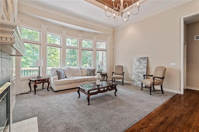 14740 W 128th St, Olathe, KS 66062 - living area with ornamental molding, a chandelier, wood finished floors, and a tiled fireplace