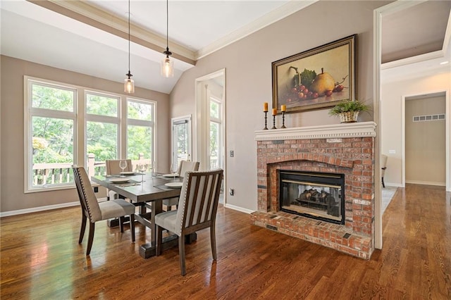 14740 W 128th St, Olathe, KS 66062 - dining space with wood finished floors, a fireplace, ornamental molding, and lofted ceiling
