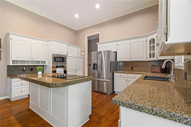 14740 W 128th St, Olathe, KS 66062 - kitchen featuring appliances with stainless steel finishes, ornamental molding, white cabinets, backsplash, and a center island
