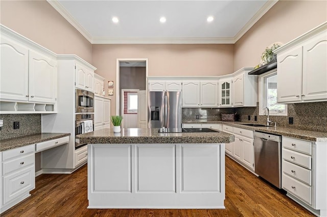 14740 W 128th St, Olathe, KS 66062 - kitchen with stainless steel appliances, a center island, tasteful backsplash, white cabinetry, and ornamental molding