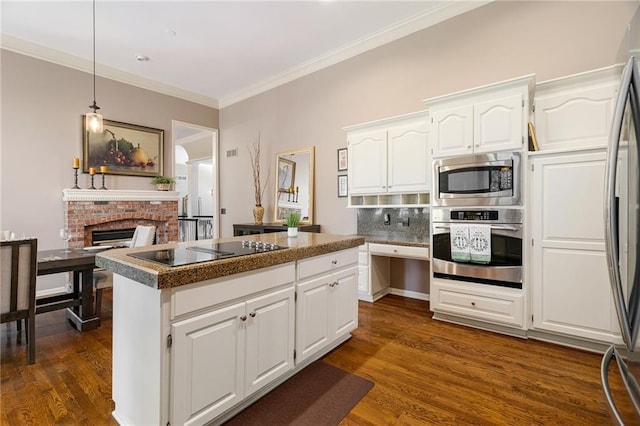 14740 W 128th St, Olathe, KS 66062 - kitchen featuring stainless steel appliances, dark wood-style floors, crown molding, white cabinets, and a kitchen island