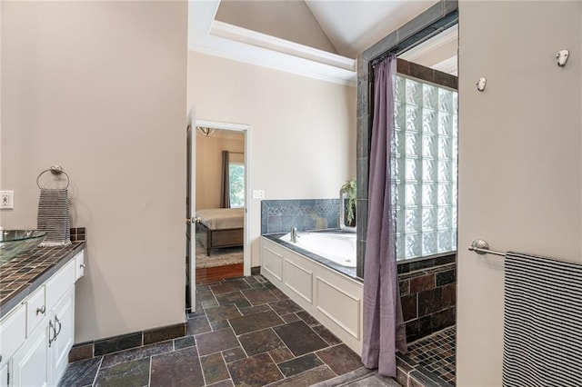 14740 W 128th St, Olathe, KS 66062 - bathroom featuring a garden tub, lofted ceiling, crown molding, vanity, and stone tile flooring