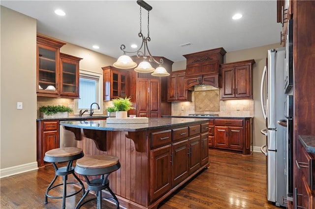 4517 N Sienna Rdg, Riverside, MO 64150 - kitchen featuring stainless steel appliances, a center island, dark wood finished floors, backsplash, and recessed lighting