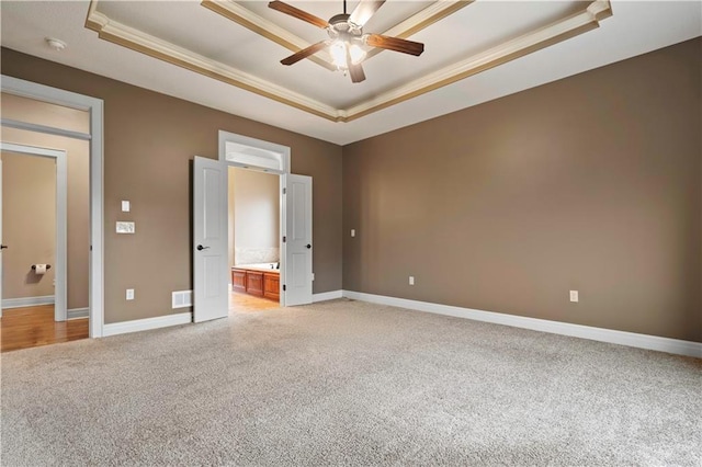 4517 N Sienna Rdg, Riverside, MO 64150 - unfurnished bedroom with a raised ceiling, light colored carpet, crown molding, ensuite bathroom, and a ceiling fan