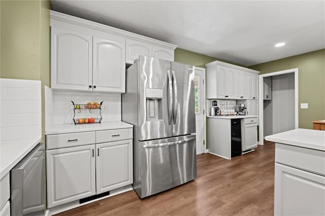 22420 W 73rd Ter, Shawnee, KS 66227 - kitchen featuring stainless steel refrigerator with ice dispenser, white cabinets, wood finished floors, backsplash, and recessed lighting