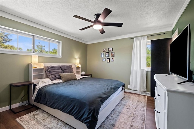 22420 W 73rd Ter, Shawnee, KS 66227 - bedroom with multiple windows, dark wood-style flooring, a textured ceiling, and ceiling fan