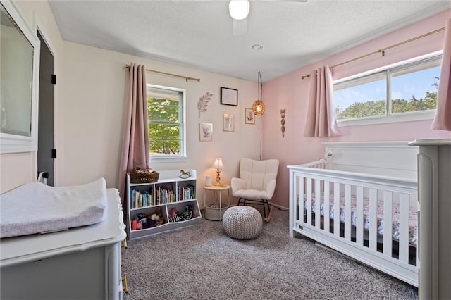 22420 W 73rd Ter, Shawnee, KS 66227 - carpeted bedroom featuring a nursery area, a textured ceiling, and ceiling fan