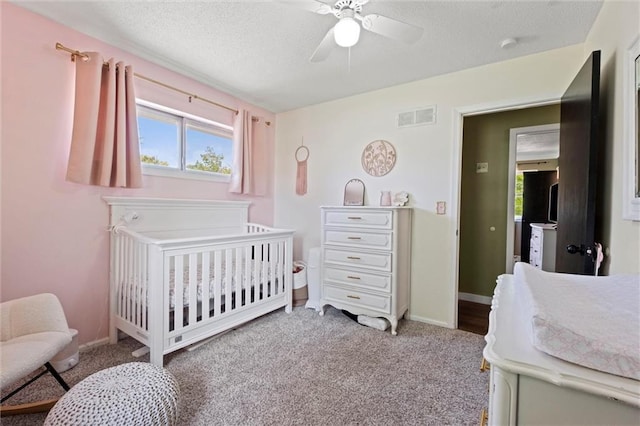22420 W 73rd Ter, Shawnee, KS 66227 - bedroom with multiple windows, a nursery area, a textured ceiling, ceiling fan, and carpet