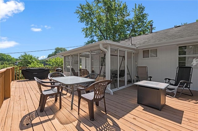 22420 W 73rd Ter, Shawnee, KS 66227 - wooden terrace with a sunroom, outdoor dining space, and a fire pit
