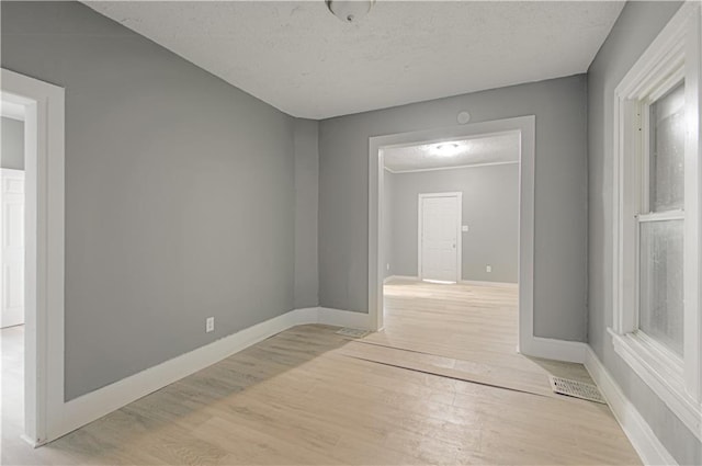2524 Askew Ave, Kansas City, MO 64127 - empty room with light wood-style flooring and a textured ceiling