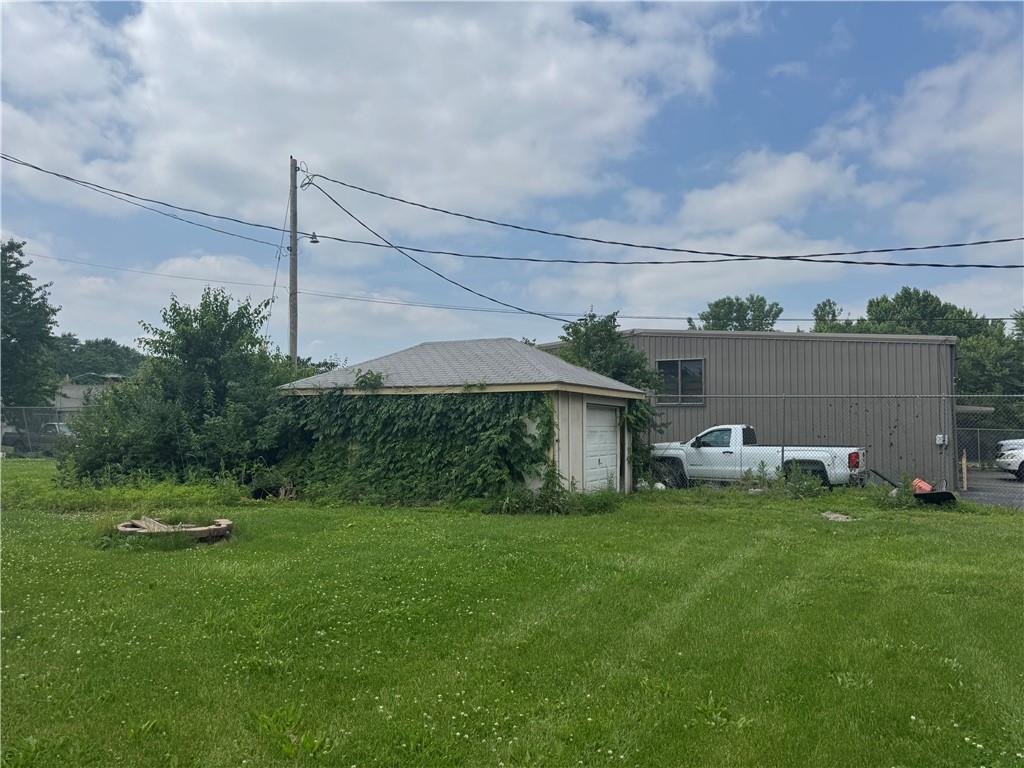 115 S Julia St, Olathe, KS 66061 - view of yard with a garage