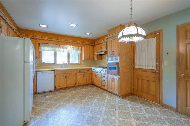 1933 N 83rd Ter, Kansas City, KS 66112 - kitchen with appliances with stainless steel finishes, light countertops, under cabinet range hood, pendant lighting, and light flooring