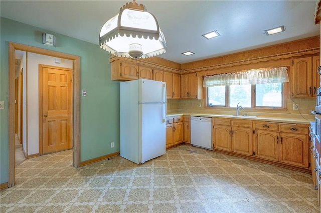 1933 N 83rd Ter, Kansas City, KS 66112 - kitchen featuring white appliances, light countertops, tasteful backsplash, and brown cabinets