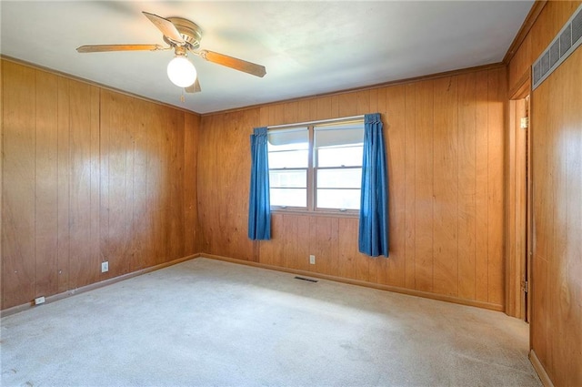 1933 N 83rd Ter, Kansas City, KS 66112 - carpeted spare room featuring ceiling fan and wood walls