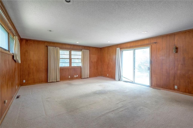 1933 N 83rd Ter, Kansas City, KS 66112 - unfurnished room featuring wooden walls, a textured ceiling, light carpet, and recessed lighting
