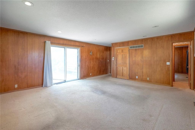1933 N 83rd Ter, Kansas City, KS 66112 - unfurnished room with wood walls, light carpet, and recessed lighting