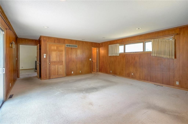 1933 N 83rd Ter, Kansas City, KS 66112 - unfurnished room featuring wood walls and light colored carpet