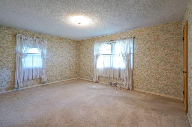 1933 N 83rd Ter, Kansas City, KS 66112 - empty room with wallpapered walls, a textured ceiling, and carpet