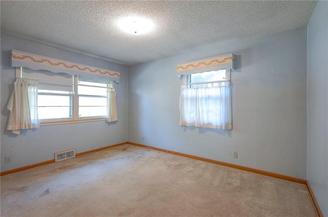 1933 N 83rd Ter, Kansas City, KS 66112 - unfurnished room featuring plenty of natural light, carpet, and a textured ceiling