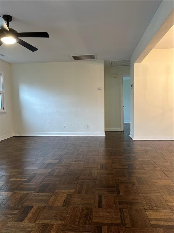 4428 N Monroe Ave, Kansas City, MO 64117 - spare room featuring ceiling fan and baseboards