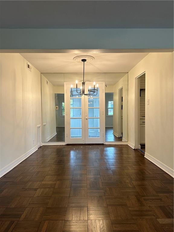 4428 N Monroe Ave, Kansas City, MO 64117 - unfurnished dining area with a chandelier and french doors