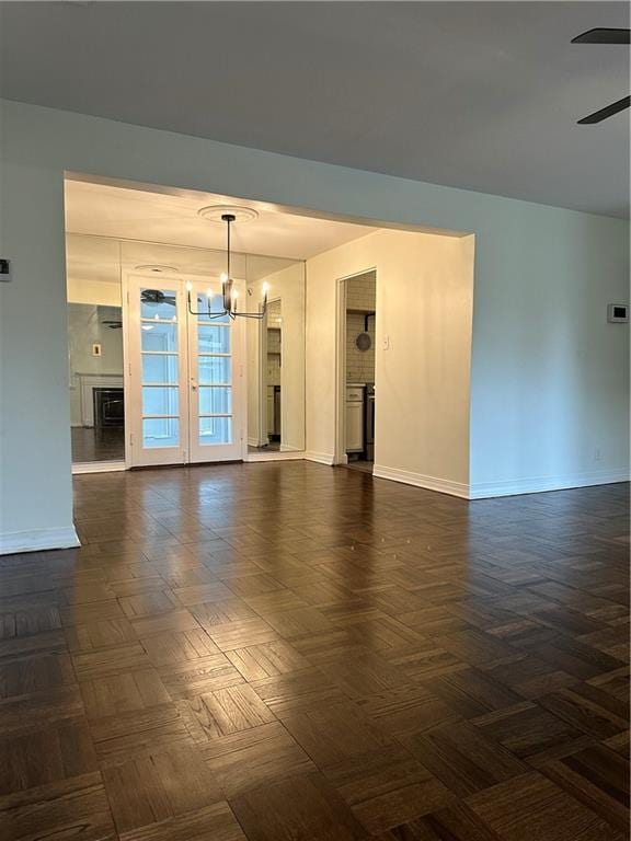 4428 N Monroe Ave, Kansas City, MO 64117 - empty room featuring a chandelier and ceiling fan