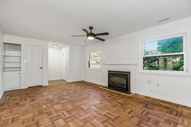 4428 N Monroe Ave, Kansas City, MO 64117 - unfurnished living room with baseboards and a ceiling fan